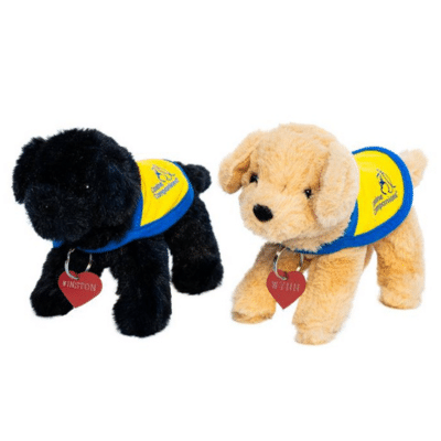 Two plush toy dogs, one black and one tan, wearing blue vests with yellow insignia. The black dog is named "Winston" and the tan dog is named "Winnie."